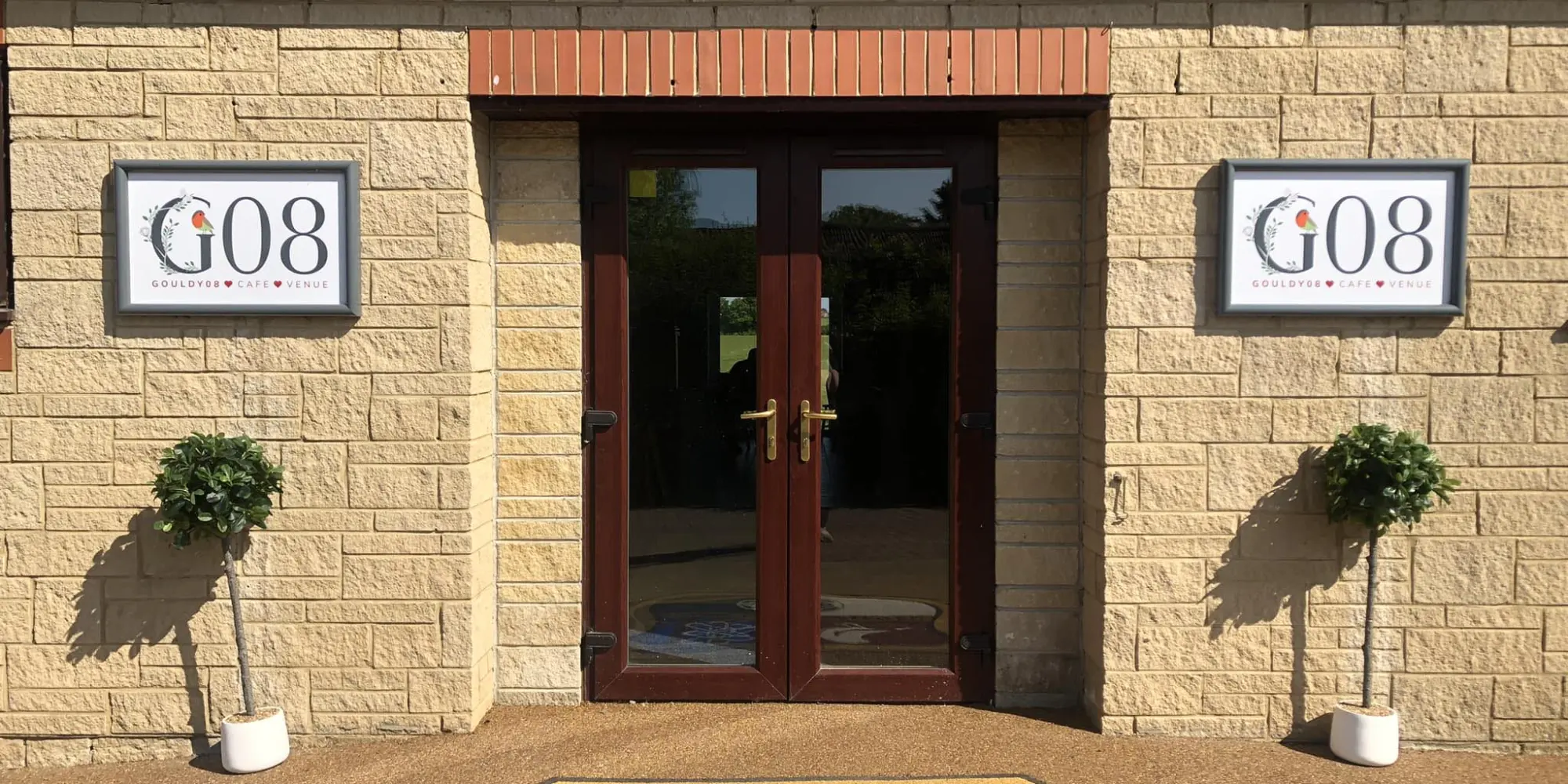 The entrance to Gouldy08 cafe and sports bar with the G08 signs either side of the door